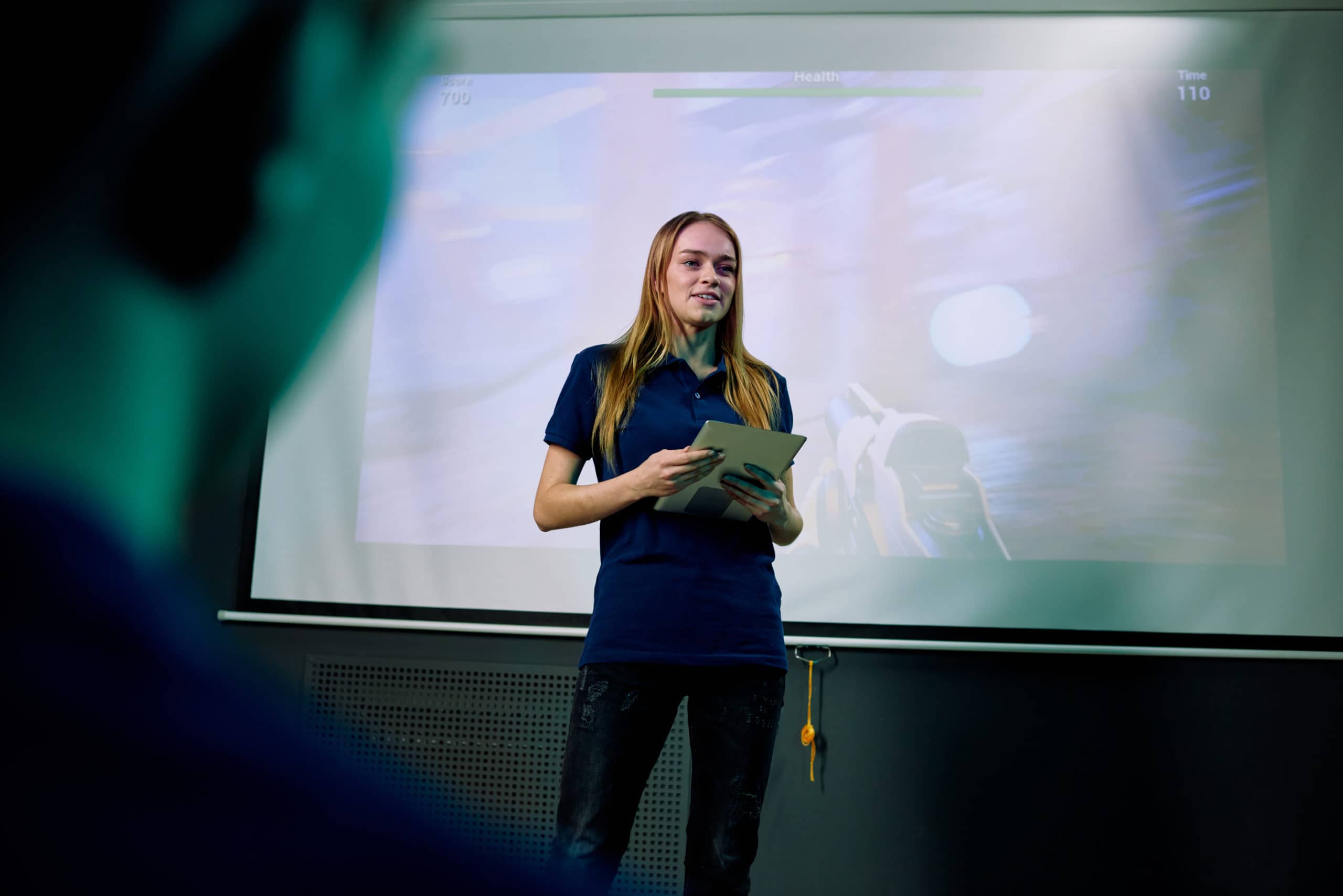 Young confident female developer of new network video game with tablet